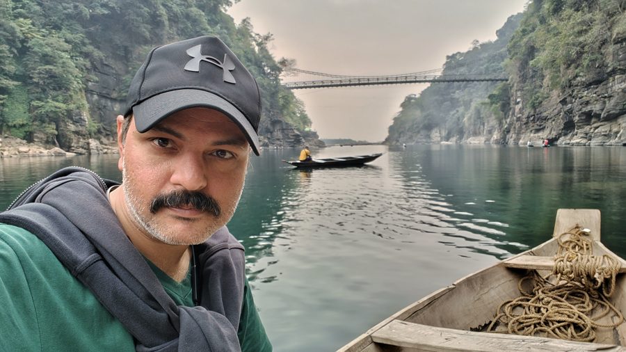 AB on a boat on the river at Dawki
